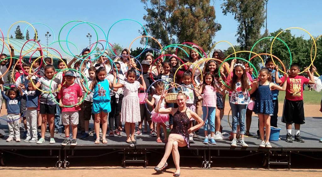 Hillia Hula hula with a group of kids holding hula hoops